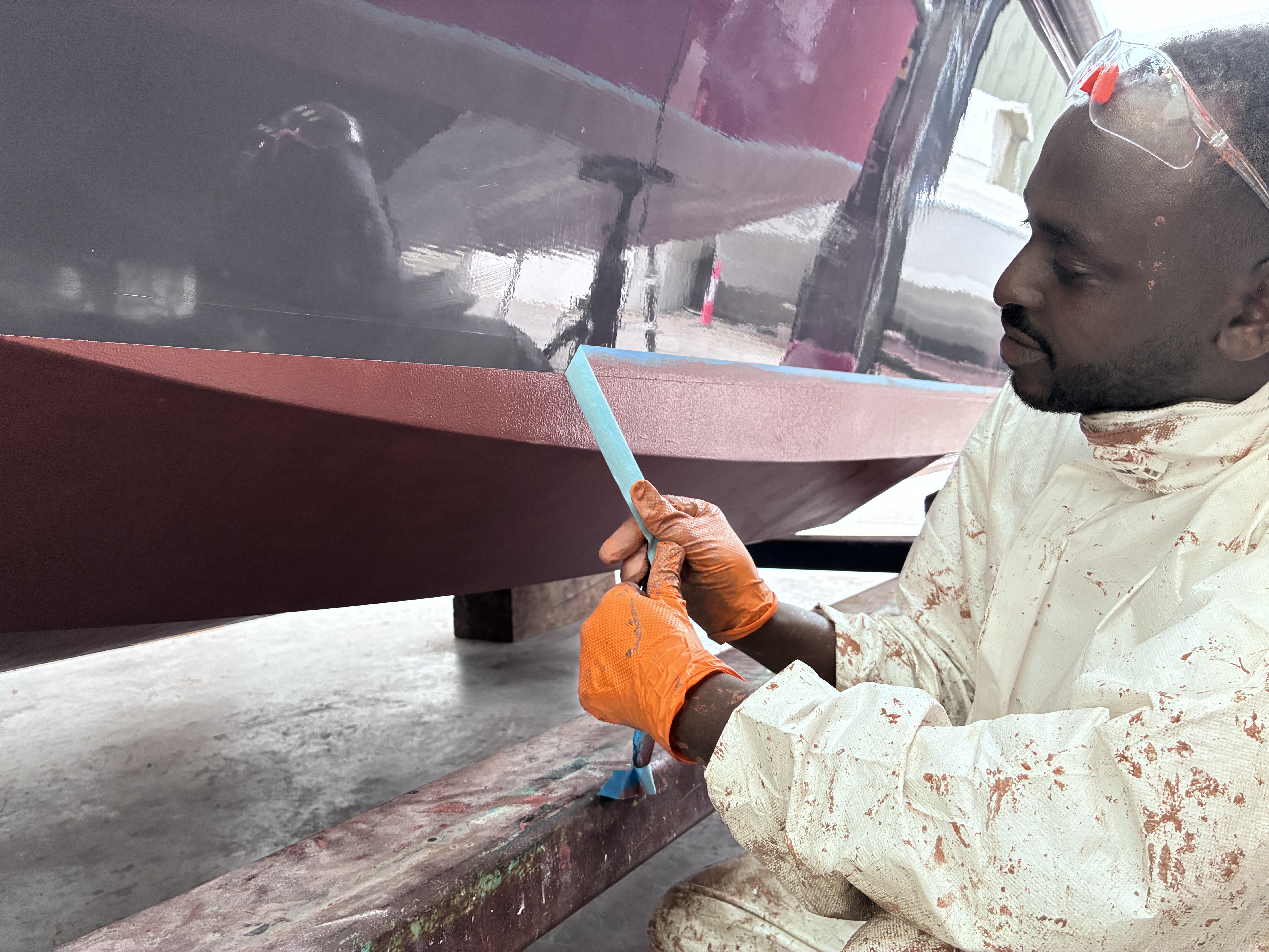 Harbour Shine applying a copper epoxy coating to a boat hull